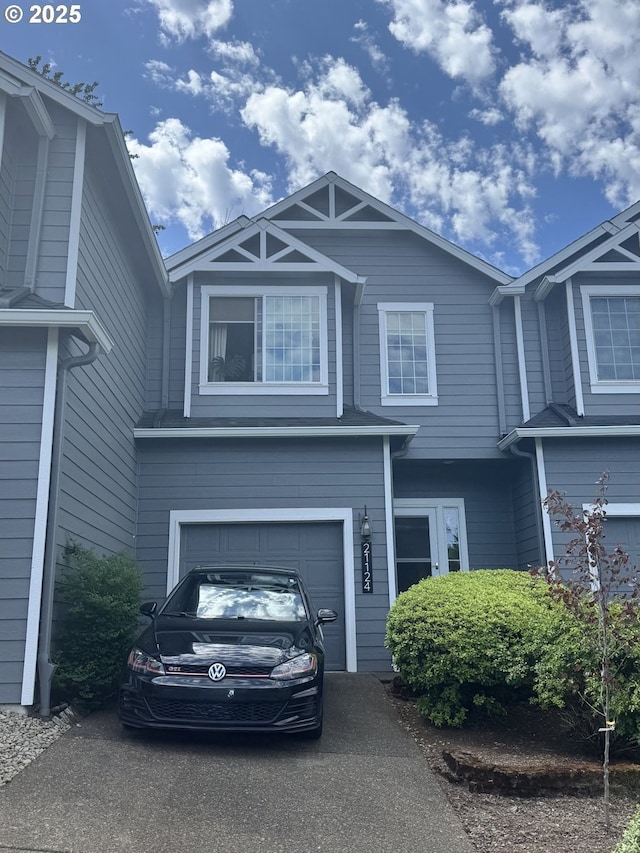 view of front of property with an attached garage and asphalt driveway