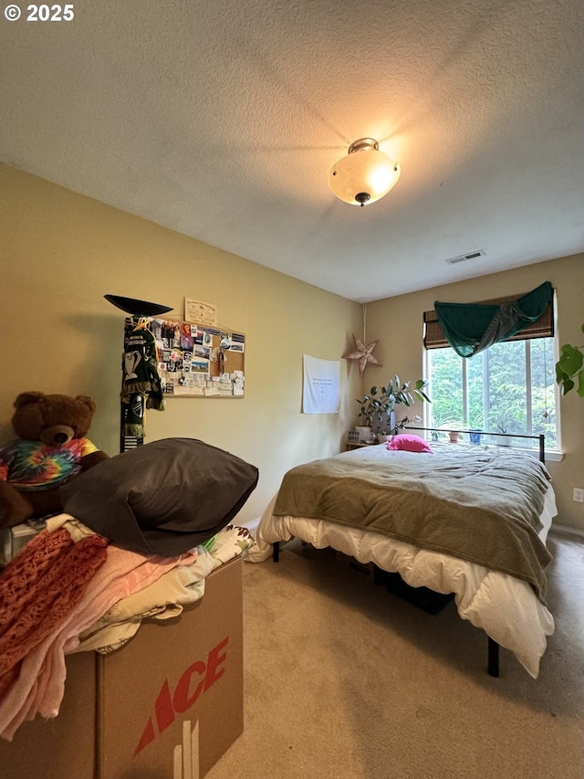 bedroom featuring carpet and a textured ceiling