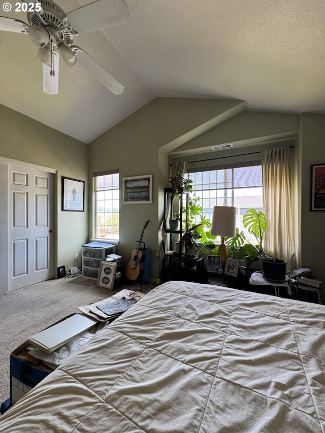 carpeted bedroom featuring vaulted ceiling and a ceiling fan
