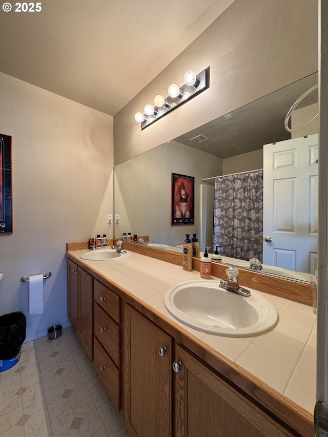 full bathroom featuring double vanity and a shower with curtain