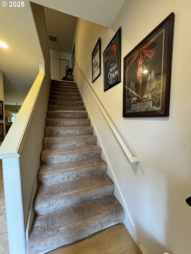 staircase with baseboards and wood finished floors