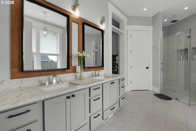 bathroom with a shower with door and vanity