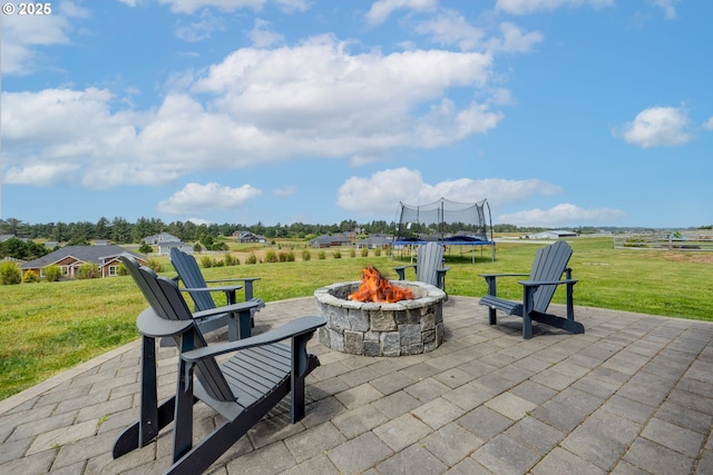 view of patio / terrace with a trampoline and a fire pit