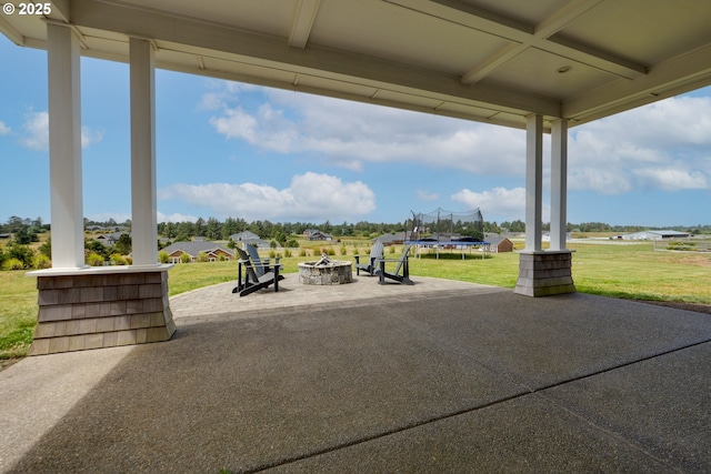 view of patio / terrace with a trampoline and a fire pit