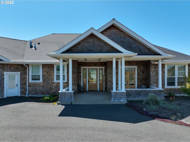 view of front of home with french doors and a porch