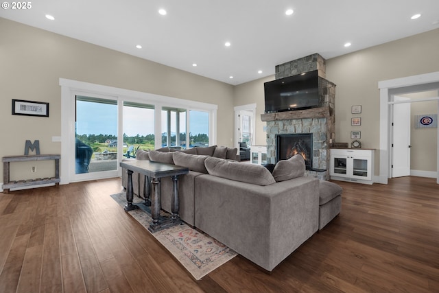 living room with dark wood-type flooring and a fireplace