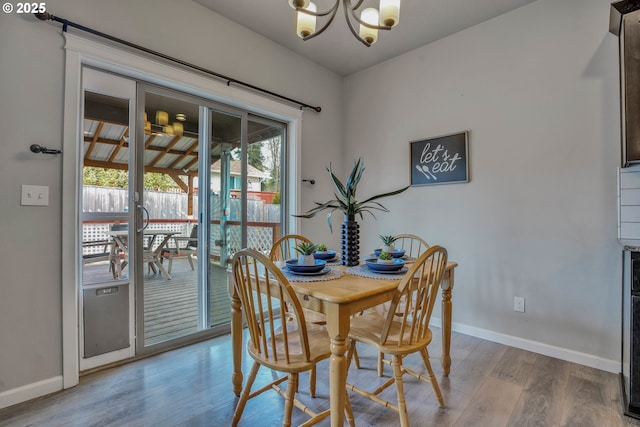 dining room featuring light hardwood / wood-style floors and a chandelier