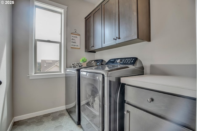 laundry area featuring washing machine and dryer and cabinets