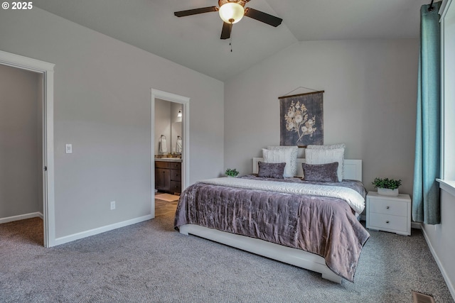 carpeted bedroom with ceiling fan, connected bathroom, and vaulted ceiling