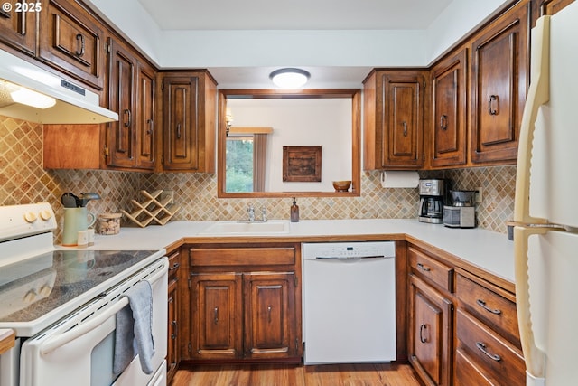 18308 NE Cole Witter Rd, Battle Ground, WA 98604 - kitchen with white appliances, a sink, under cabinet range hood, decorative backsplash, and light countertops