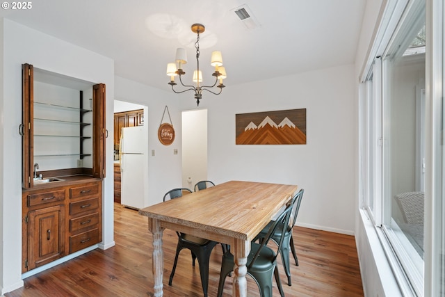 18308 NE Cole Witter Rd, Battle Ground, WA 98604 - dining room featuring a chandelier, wood finished floors, and baseboards