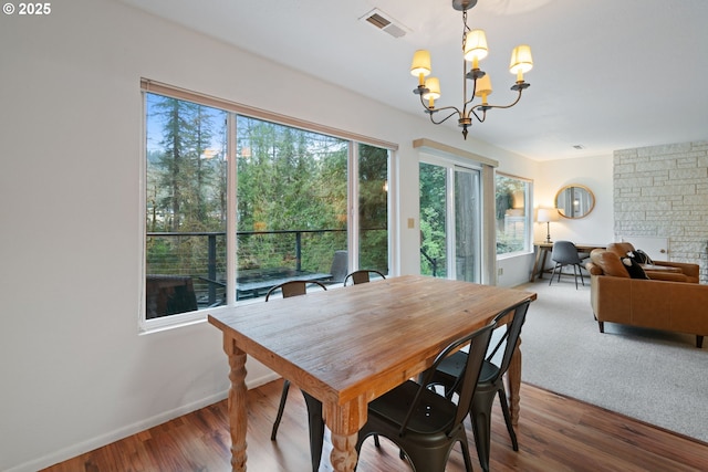 18308 NE Cole Witter Rd, Battle Ground, WA 98604 - dining area with a chandelier, wood finished floors, and baseboards