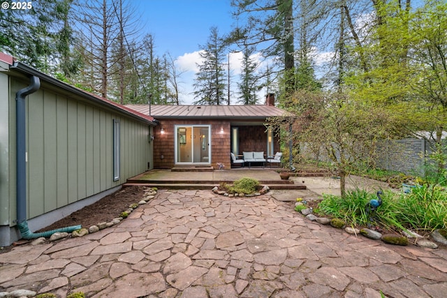 18308 NE Cole Witter Rd, Battle Ground, WA 98604 - back of property featuring an outdoor hangout area, fence, a patio area, a chimney, and metal roof