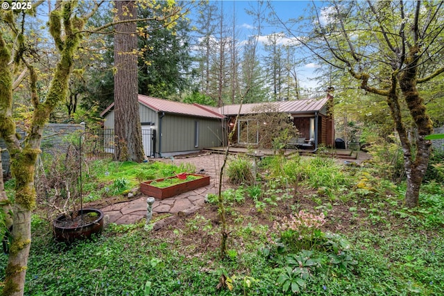 18308 NE Cole Witter Rd, Battle Ground, WA 98604 - rear view of property featuring a garden, metal roof, a standing seam roof, and fence