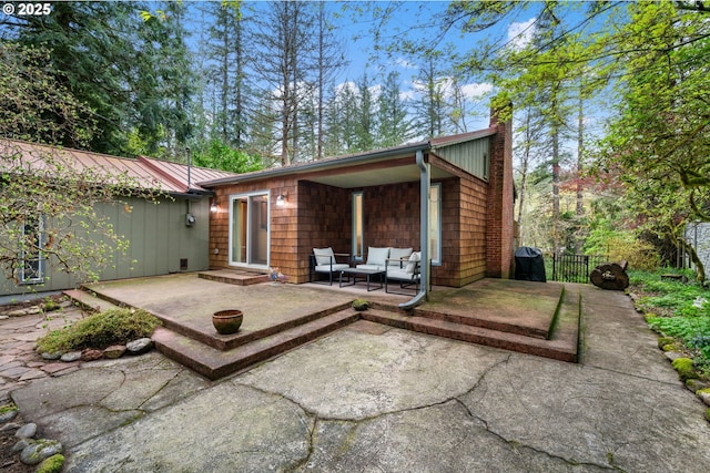 18308 NE Cole Witter Rd, Battle Ground, WA 98604 - rear view of house with a patio, a chimney, an outdoor living space, and fence