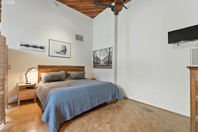 bedroom with light carpet, visible vents, wooden ceiling, and a towering ceiling