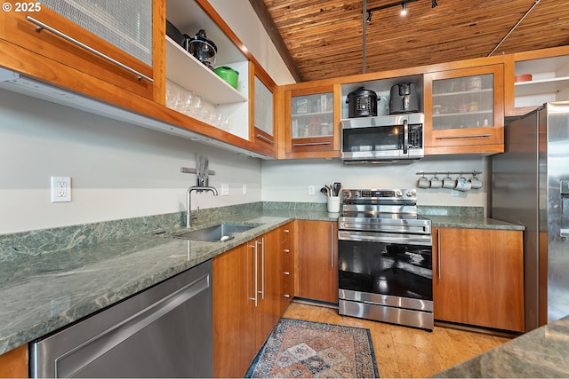 kitchen with open shelves, brown cabinets, and appliances with stainless steel finishes