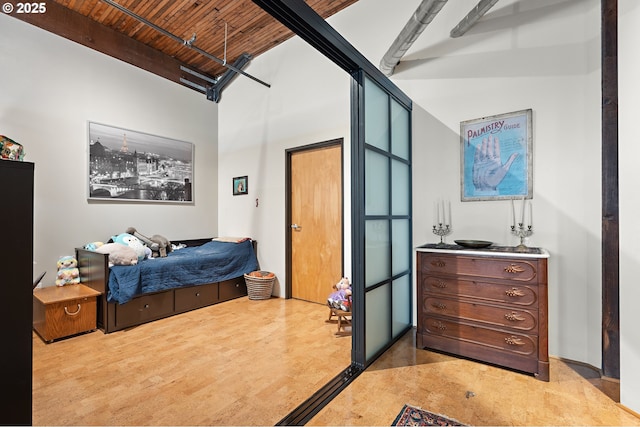 bedroom featuring beamed ceiling and wooden ceiling