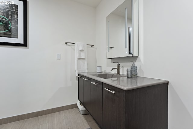 bathroom with vanity and baseboards