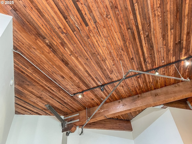 interior details with track lighting, beamed ceiling, and wood ceiling