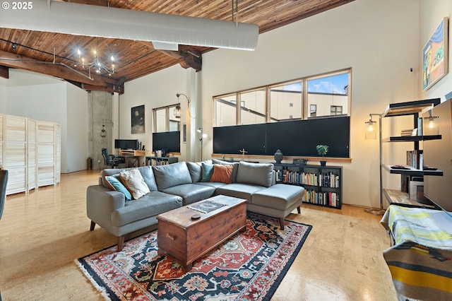 living room featuring a chandelier, wooden ceiling, and a high ceiling