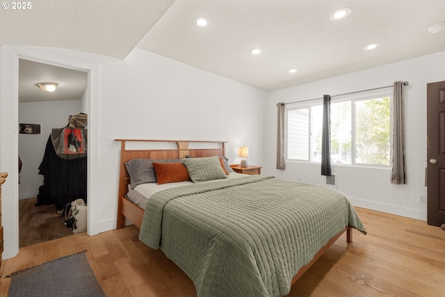 bedroom featuring baseboards, recessed lighting, and light wood finished floors