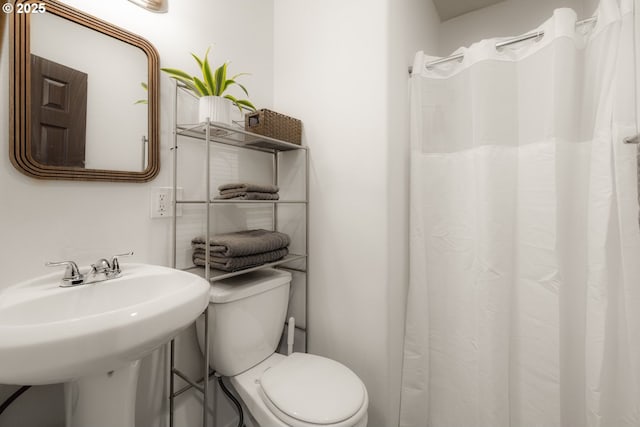 full bath featuring toilet and a sink