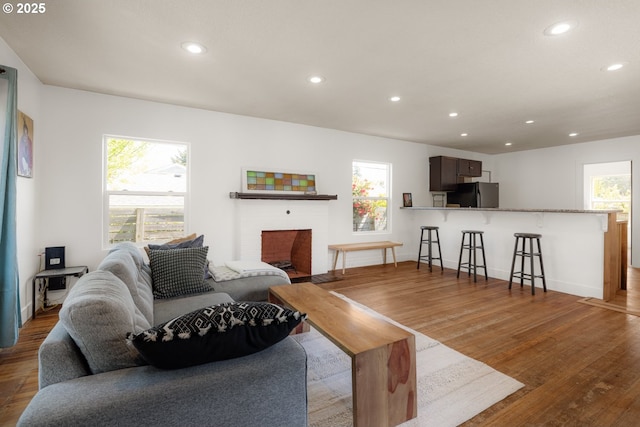 living room featuring recessed lighting, wood finished floors, and baseboards