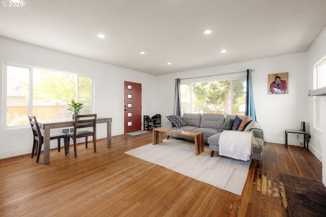living room with recessed lighting, a healthy amount of sunlight, baseboards, and light wood-style floors