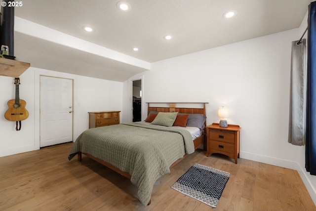 bedroom featuring baseboards, light wood-type flooring, and recessed lighting