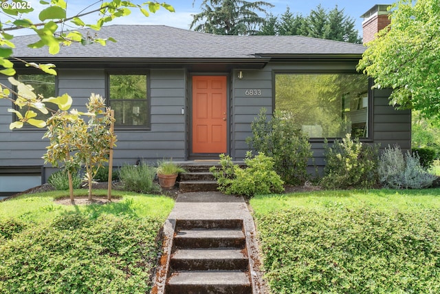6833 NE 18th Ave, Portland, OR 97211 - view of front of house with a shingled roof and a chimney