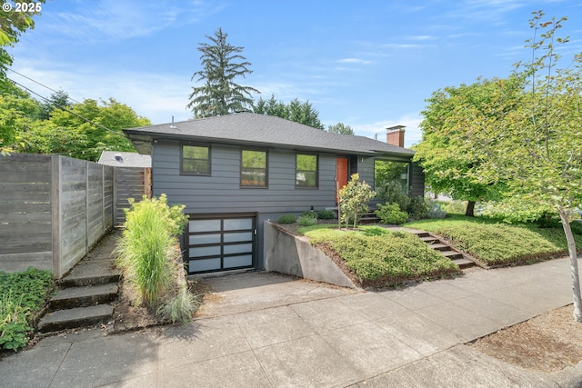 6833 NE 18th Ave, Portland, OR 97211 - view of front of house with driveway, a garage, a chimney, and a shingled roof