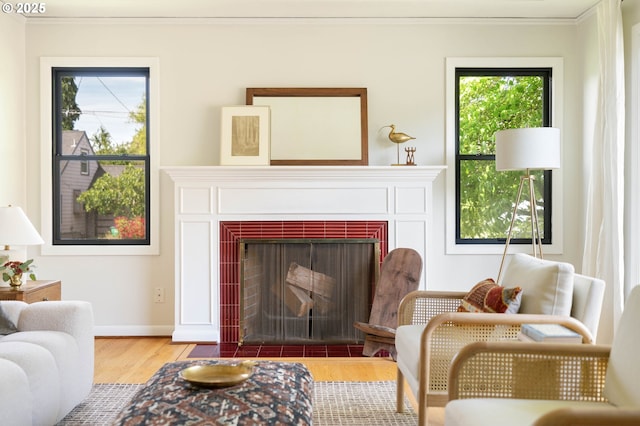 6833 NE 18th Ave, Portland, OR 97211 - living area with wood finished floors, crown molding, a fireplace with flush hearth, plenty of natural light, and baseboards