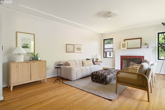 6833 NE 18th Ave, Portland, OR 97211 - living area with light wood-style floors, a brick fireplace, and baseboards