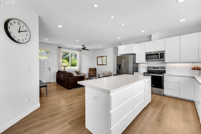 26815 NE Yacolt Rd, Yacolt, WA 98675 - kitchen with stainless steel appliances, recessed lighting, a kitchen island, light wood-style floors, and light countertops