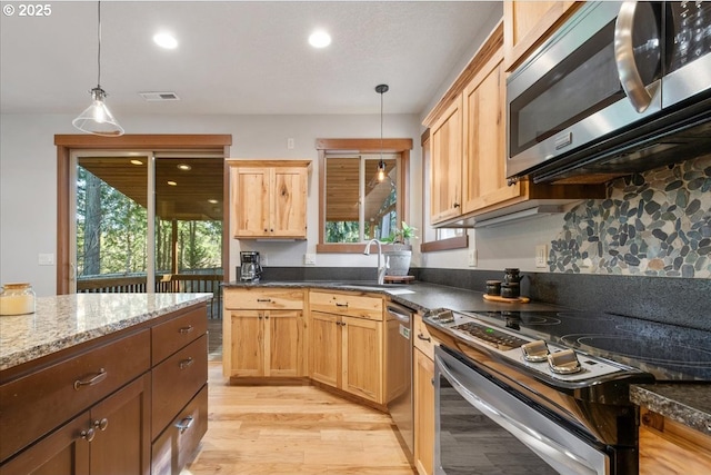 13135 SE Winston Rd, Damascus, OR 97089 - kitchen with pendant lighting, recessed lighting, a sink, light wood-style flooring, and appliances with stainless steel finishes