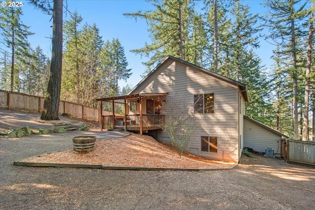 13135 SE Winston Rd, Damascus, OR 97089 - back of property with fence, a wooden deck, cooling unit, and an outdoor fire pit