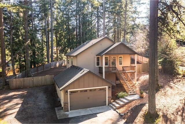 13135 SE Winston Rd, Damascus, OR 97089 - chalet / cabin with board and batten siding, a garage, stairway, fence, and stone siding
