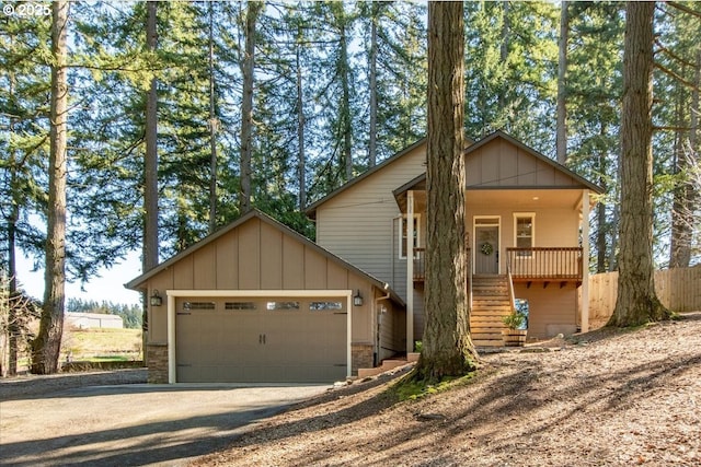 13135 SE Winston Rd, Damascus, OR 97089 - chalet / cabin with board and batten siding, driveway, an attached garage, stairs, and stone siding