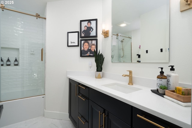 16223 SW 146th Ave, Portland, OR 97224 - bathroom featuring vanity, marble look tiles, combined bath / shower with glass door, and baseboards