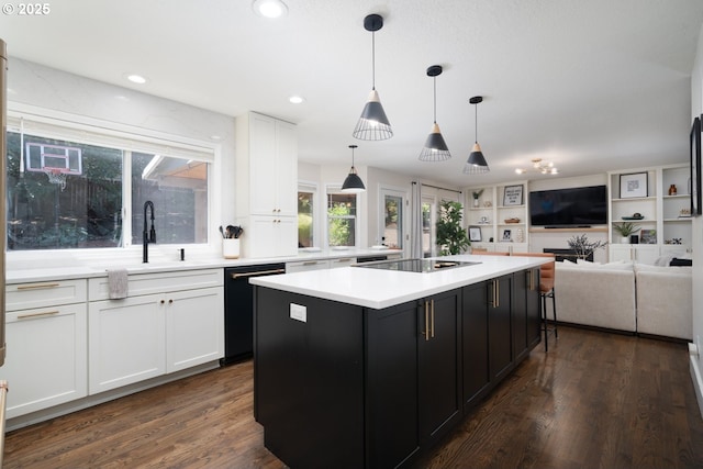 16223 SW 146th Ave, Portland, OR 97224 - kitchen with black appliances, white cabinetry, dark cabinets, a kitchen island, and recessed lighting