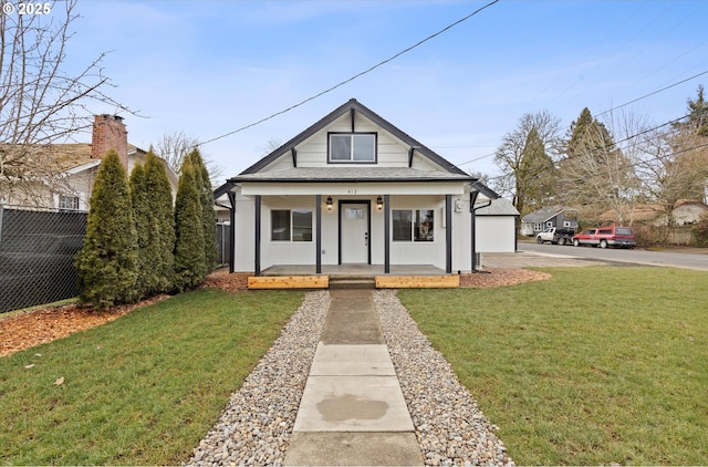 bungalow featuring a front lawn and a porch