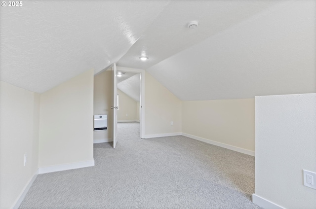412 Monmouth Ave S, Monmouth, OR 97361 - additional living space featuring baseboards, vaulted ceiling, a textured ceiling, and light colored carpet