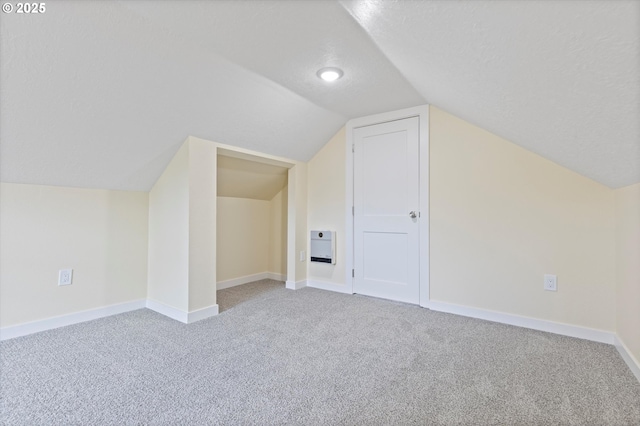 412 Monmouth Ave S, Monmouth, OR 97361 - additional living space featuring baseboards, vaulted ceiling, a textured ceiling, and carpet flooring