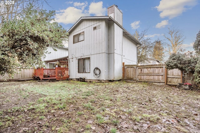 rear view of house with a wooden deck