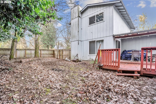 rear view of house featuring a wooden deck