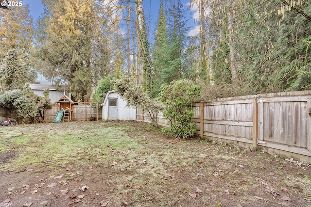 view of yard featuring a playground and a storage unit