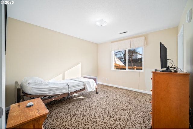 bedroom featuring visible vents and baseboards