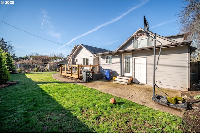 back of house featuring a patio, a wooden deck, a yard, and fence