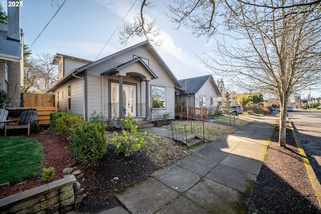 bungalow-style home with fence
